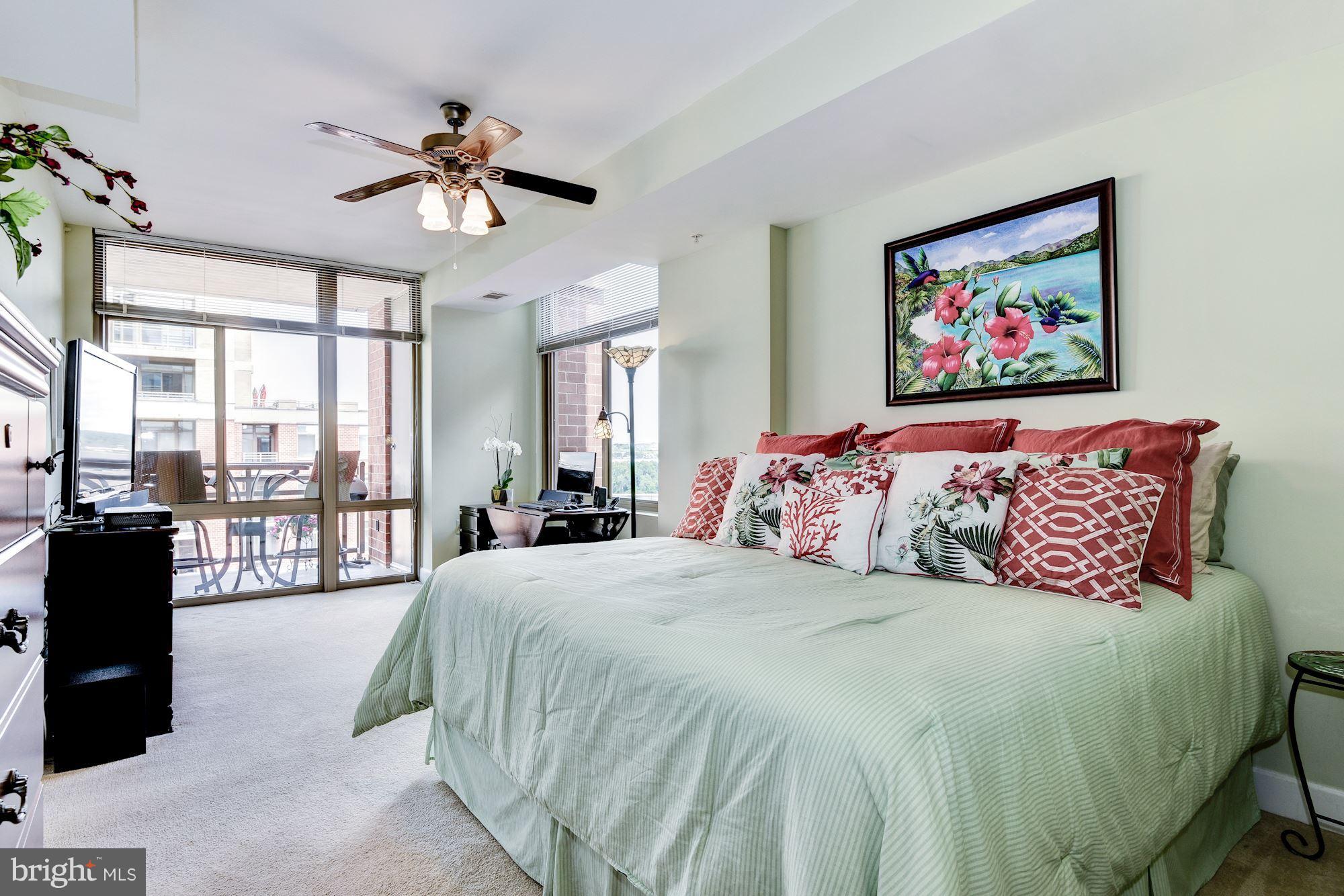 3600 South Glebe Road, Unit 918W Arlington, VA 22202 - Photo 12 of 30 a bedroom with a large bed and a chandelier