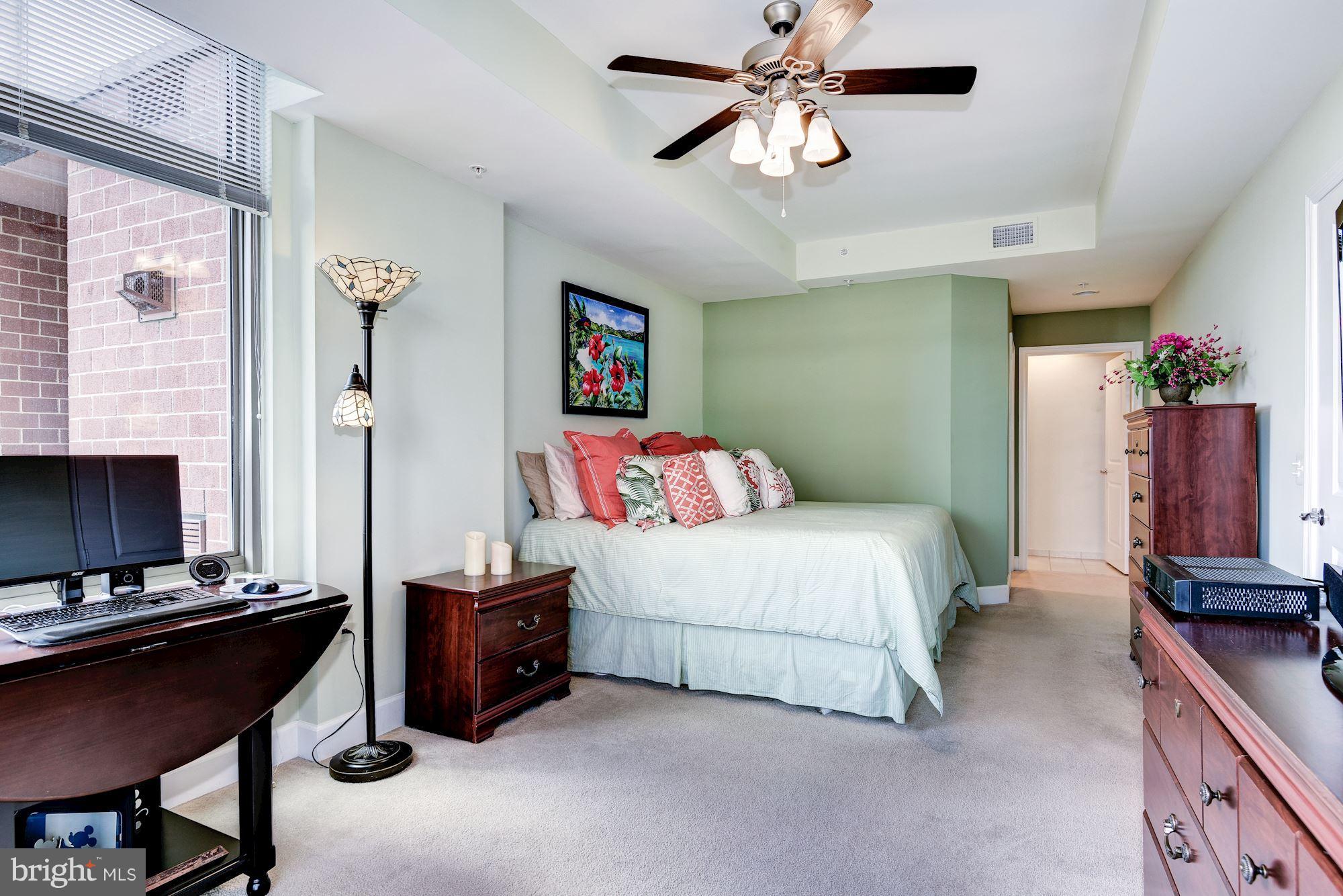 3600 South Glebe Road, Unit 918W Arlington, VA 22202 - Photo 13 of 30 a bedroom with a bed and a chandelier