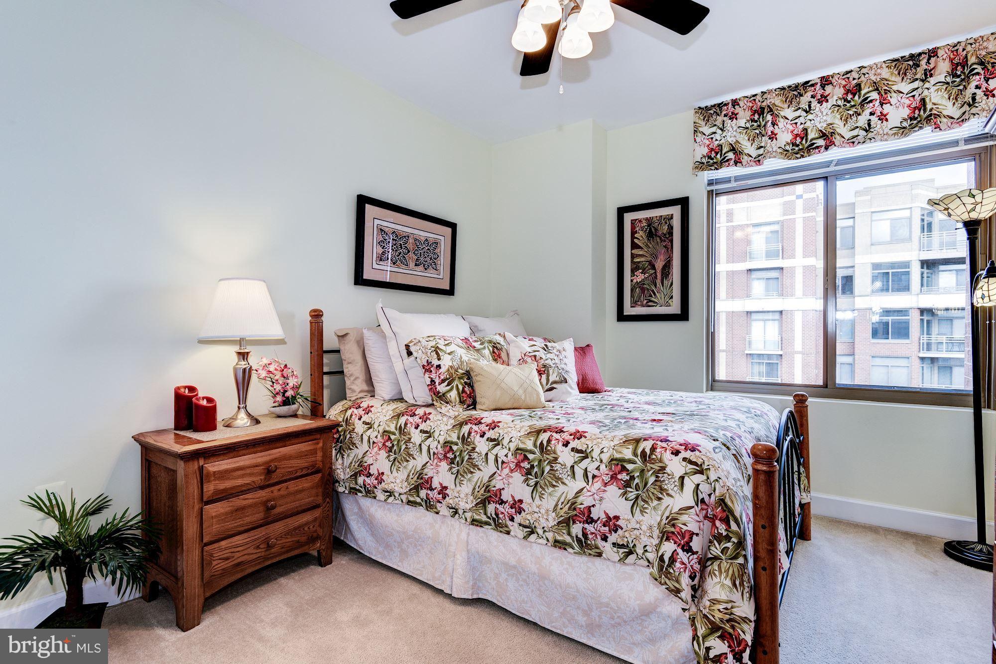 3600 South Glebe Road, Unit 918W Arlington, VA 22202 - Photo 18 of 30 a bedroom with a bed and wooden floor
