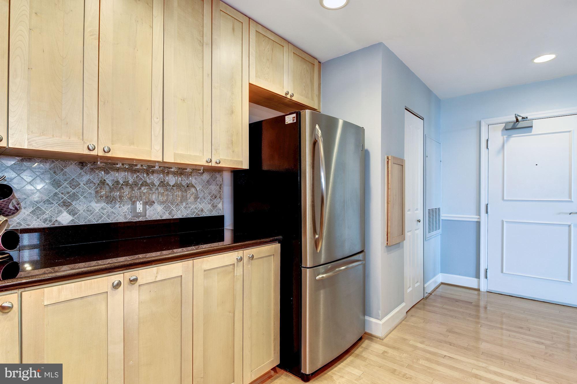 3600 South Glebe Road, Unit 918W Arlington, VA 22202 - Photo 4 of 30 a kitchen with stainless steel appliances granite countertop a refrigerator a stove and a microwave
