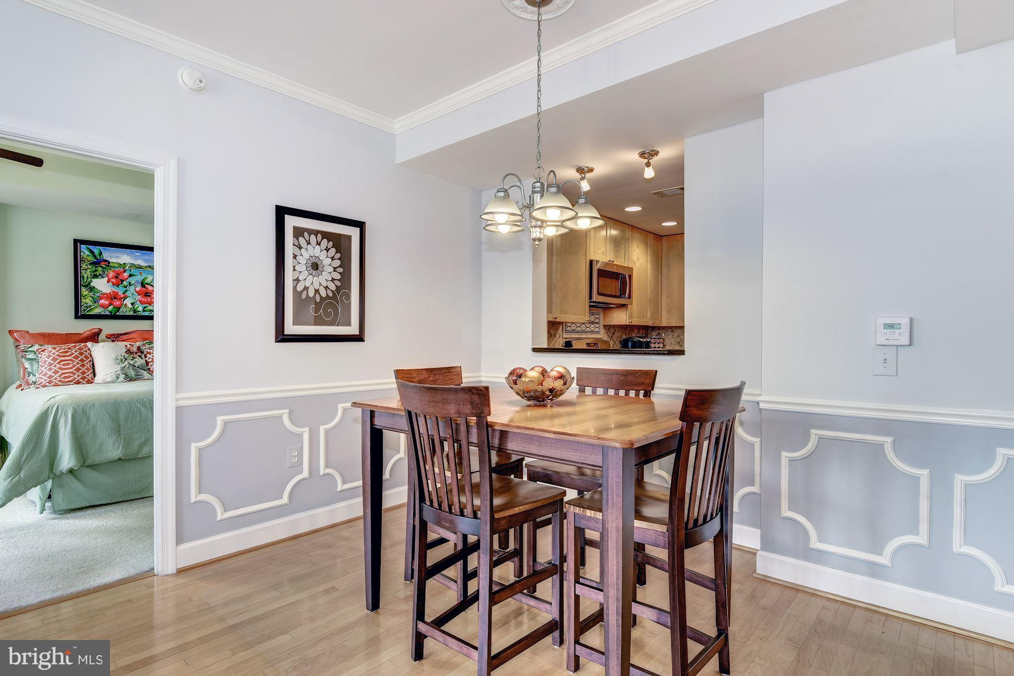 3600 South Glebe Road, Unit 918W Arlington, VA 22202 - Photo 9 of 30 a view of a dining room with furniture and wooden floor