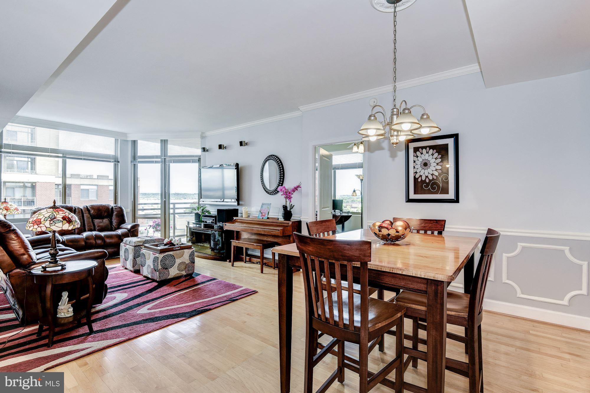 3600 South Glebe Road, Unit 918W Arlington, VA 22202 - Photo 10 of 30 a view of a dining room and livingroom with furniture wooden floor a chandelier