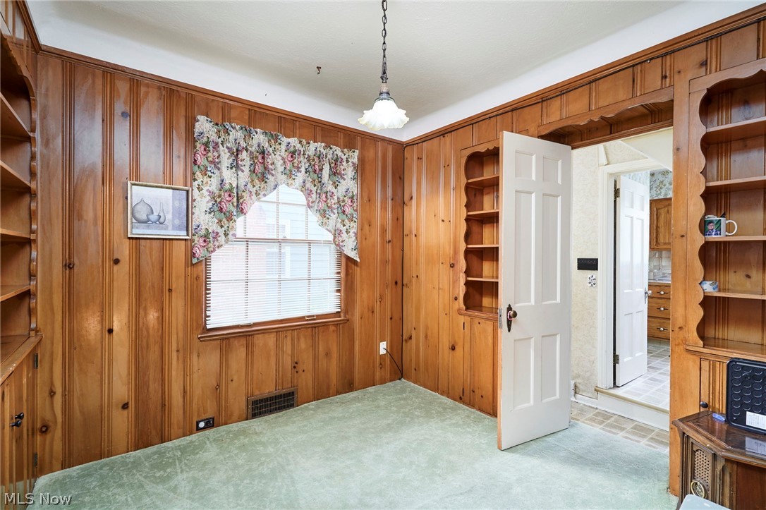3676 Rawnsdale Road Beachwood, OH 44122 - Photo 6 of 20 Unfurnished dining area featuring carpet flooring and wood walls