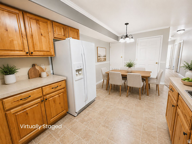 8198 North Cedar Springs Road, Unit T6 Eagle Mountain, UT 84005 - Photo 2 of 13 Kitchen and dining area featuring light-toned wood cabinetry, a white side-by-side refrigerator, and a neutral-toned countertop