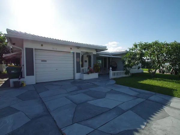 a view of a house with a yard and garage