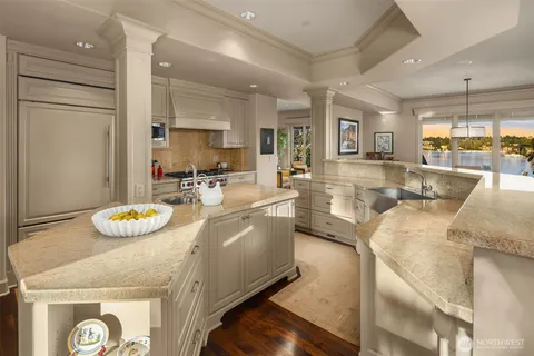 a dining hall with stainless steel appliances granite countertop a stove and a dining table with kitchen view