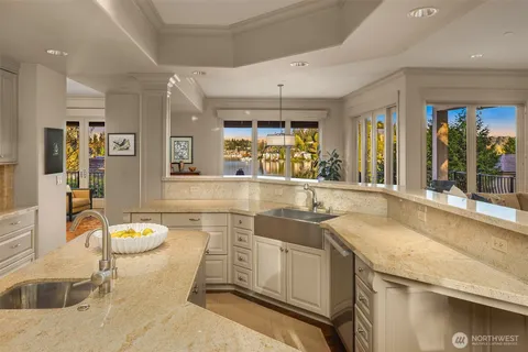 a large kitchen with granite countertop a sink and a counter top space