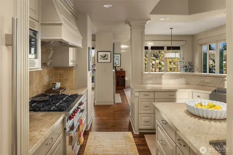 a kitchen with stainless steel appliances granite countertop a stove and a wooden cabinets