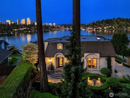 a aerial view of a house with swimming pool garden and lake view