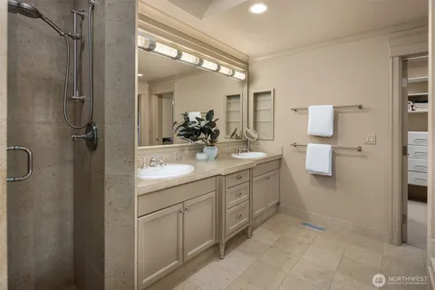 a bathroom with a double vanity sink a mirror and a toilet