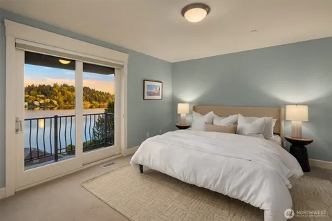 a large bed sitting in a bedroom next to a window