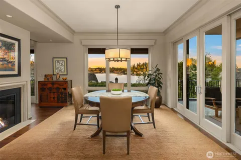 a dining room with furniture a fireplace and wooden floor