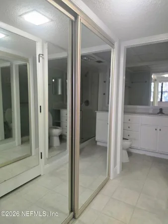 a bathroom with a glass door shower a sink and a mirror