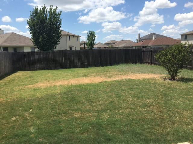 14420 Cummins Way Manor, TX 78653 - Photo 20 of 20 Fenced backyard featuring an established shrub and a mix of grass and natural ground cover