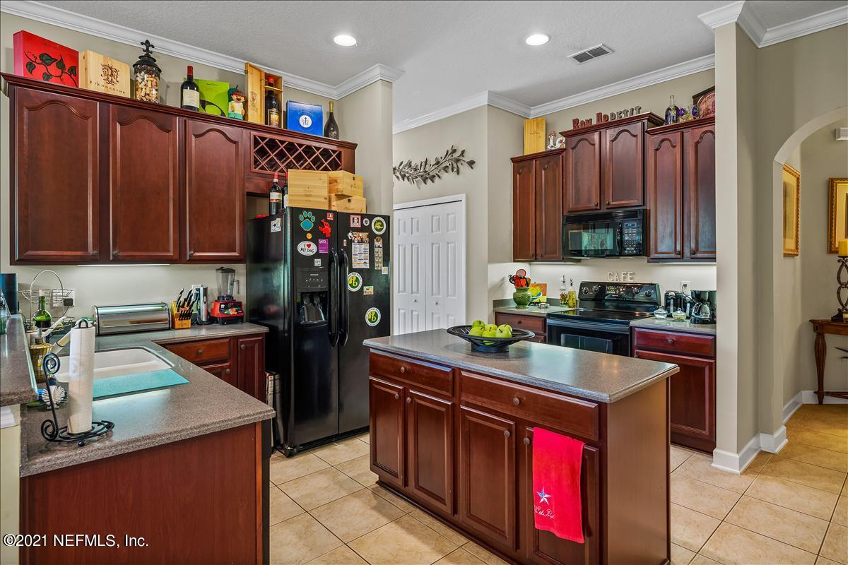 812 Riley Lane St. Augustine, FL 32095 - Photo 11 of 35 a kitchen with stainless steel appliances granite countertop a stove a refrigerator and a sink