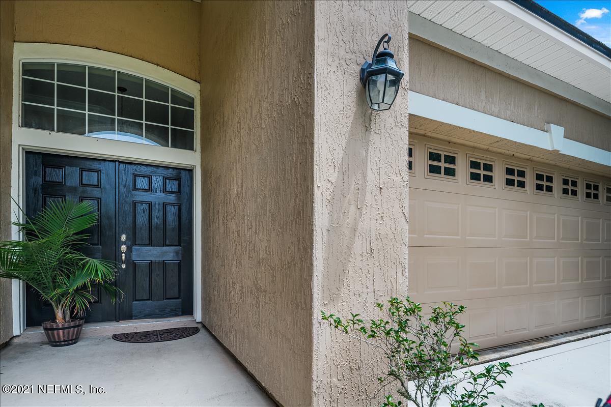 812 Riley Lane St. Augustine, FL 32095 - Photo 4 of 35 a glass door with a potted plant on it