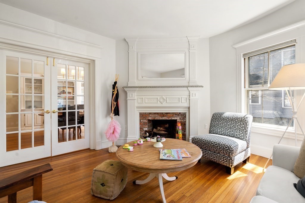 19 Elmore Street Newton, MA 02459 - Photo 19 of 40 a living room with furniture a fireplace and a large window
