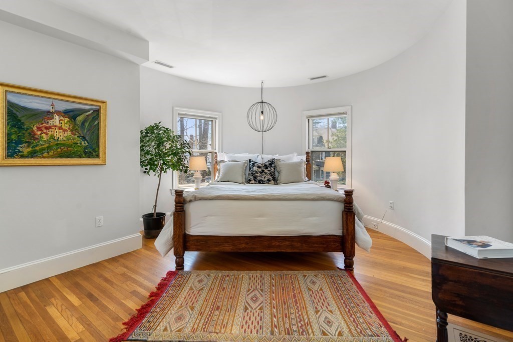 19 Elmore Street Newton, MA 02459 - Photo 23 of 40 a bedroom with a bed and wooden floor