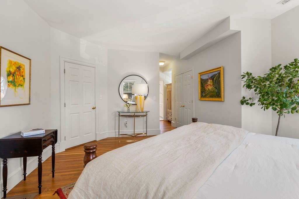 19 Elmore Street Newton, MA 02459 - Photo 24 of 40 a bedroom with a bed and a potted plant