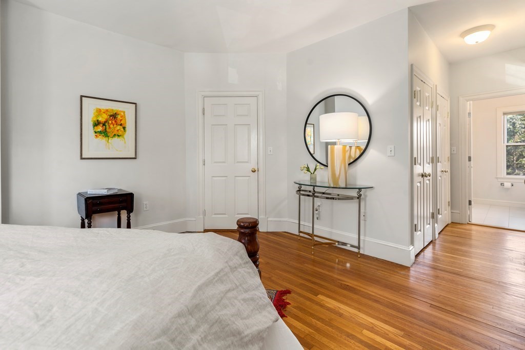 19 Elmore Street Newton, MA 02459 - Photo 25 of 40 a bedroom with a bed and a chandelier