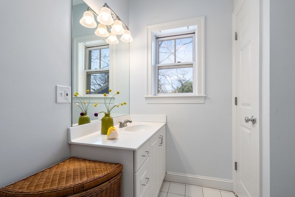 19 Elmore Street Newton, MA 02459 - Photo 30 of 40 a bathroom with a sink a vanity and a mirror