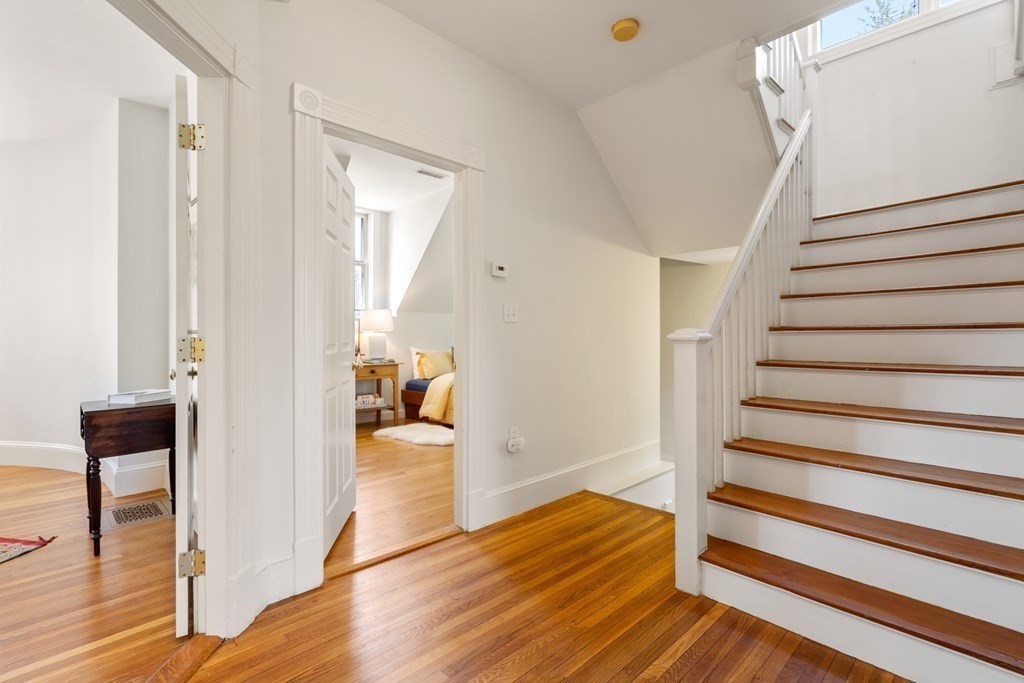 19 Elmore Street Newton, MA 02459 - Photo 32 of 40 a view of a hallway with wooden floor and staircase