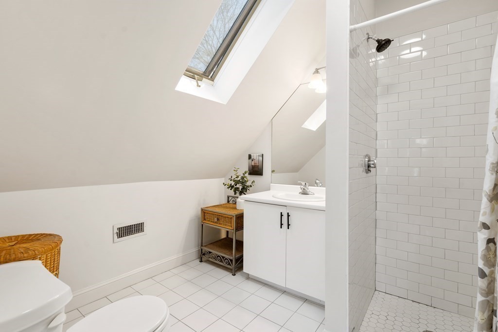 19 Elmore Street Newton, MA 02459 - Photo 35 of 40 a bathroom with a sink a toilet and shower