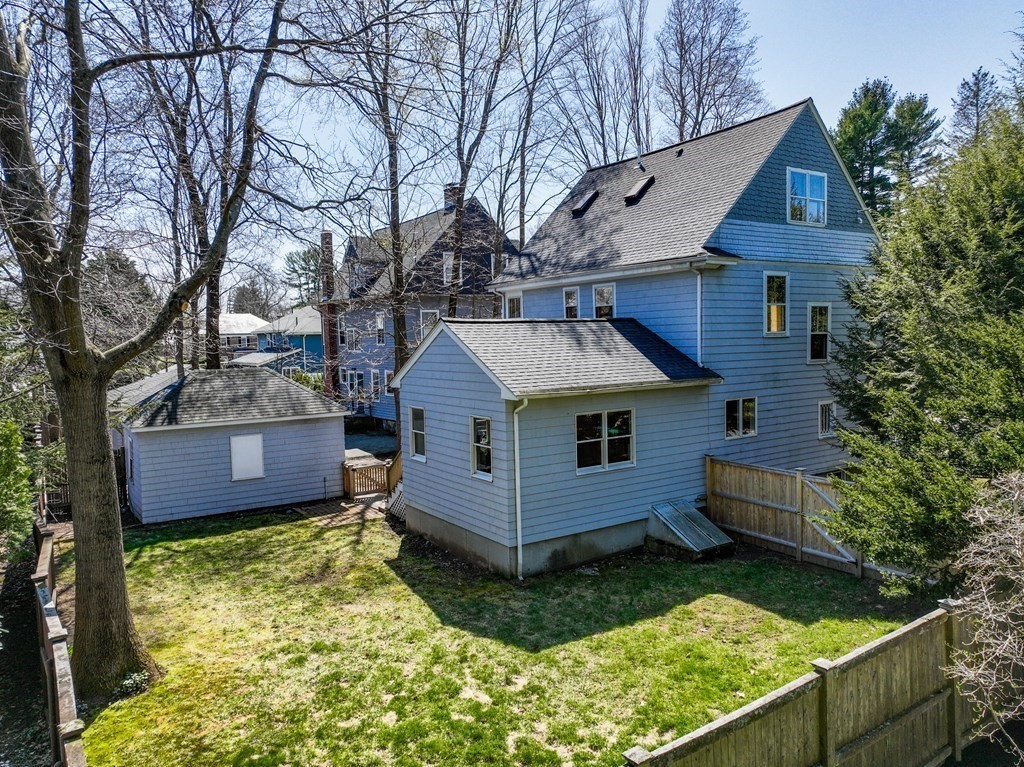 19 Elmore Street Newton, MA 02459 - Photo 39 of 40 a view of a house with a small yard and wooden fence