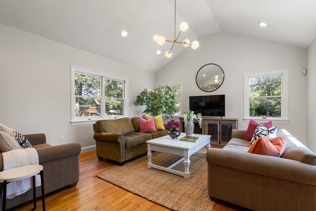 19 Elmore Street Newton, MA 02459 - Photo 4 of 40 a living room with furniture a large window and a fireplace