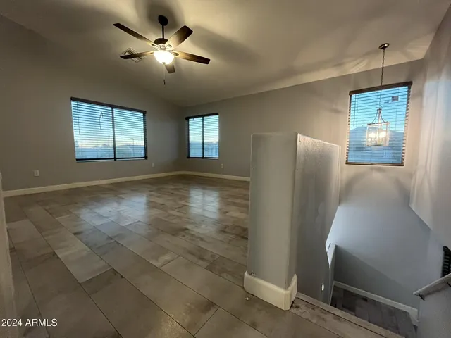 a view of a livingroom with a ceiling fan and window