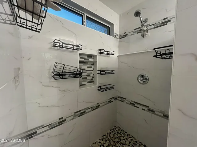a bathroom with a shower and vanity