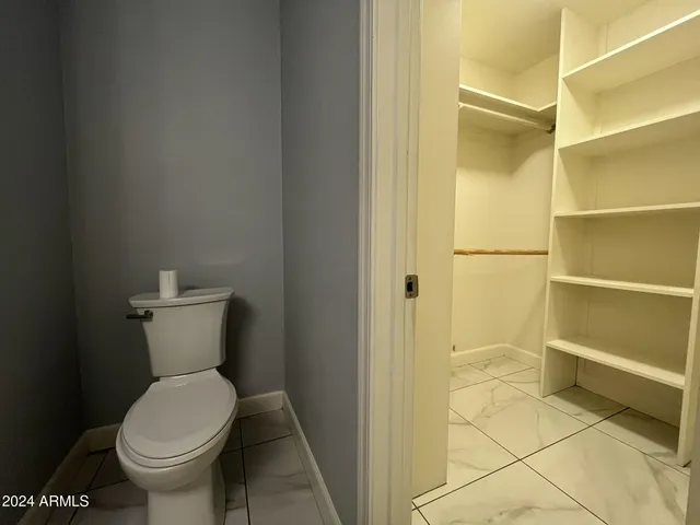a white toilet sitting next to a bathroom sink