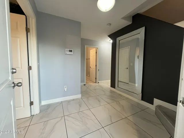 a view of a livingroom with wooden cabinets