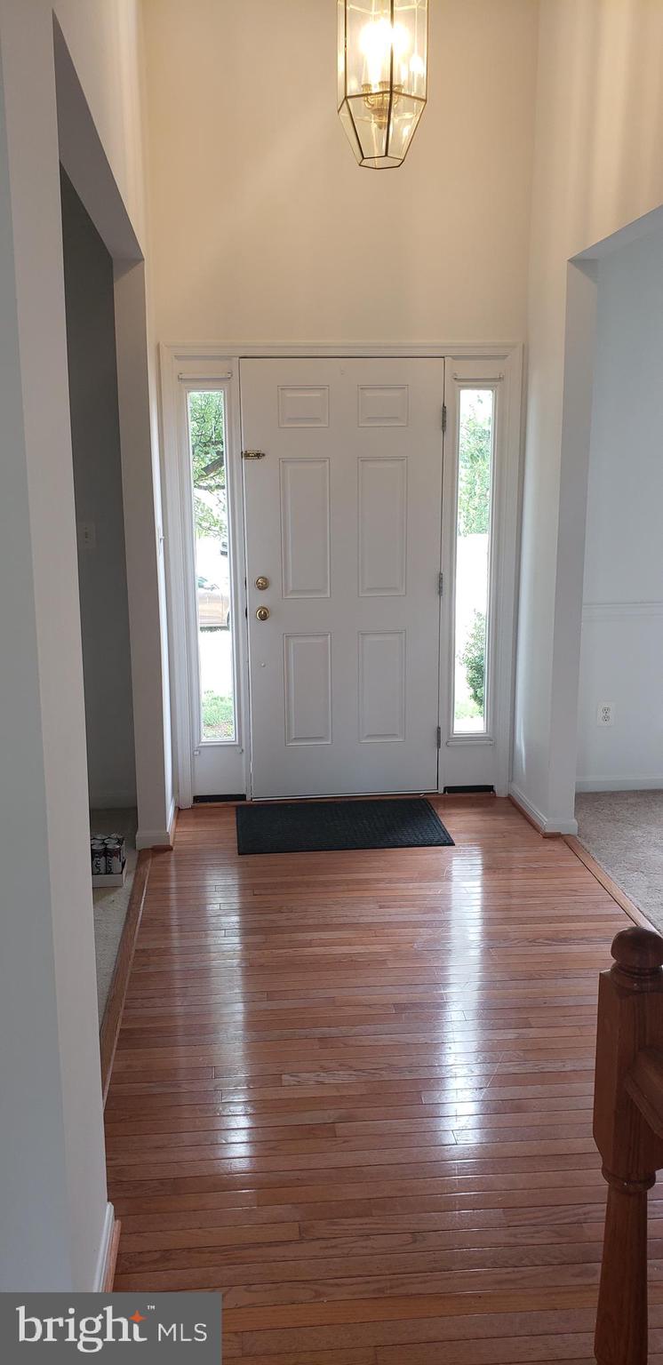 863 Fox Den Road Culpeper, VA 22701 - Photo 21 of 28 an empty room with wooden floor mirror and windows