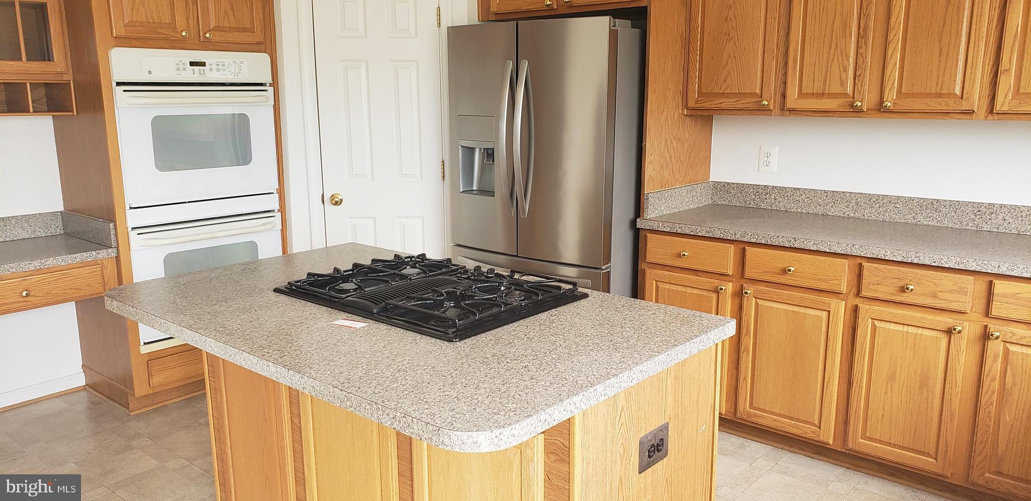 863 Fox Den Road Culpeper, VA 22701 - Photo 24 of 28 a kitchen with a stove and a refrigerator