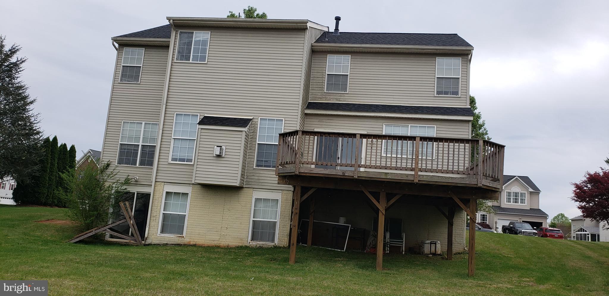 863 Fox Den Road Culpeper, VA 22701 - Photo 6 of 28 a view of a house with a barbeque grill and a wooden fence