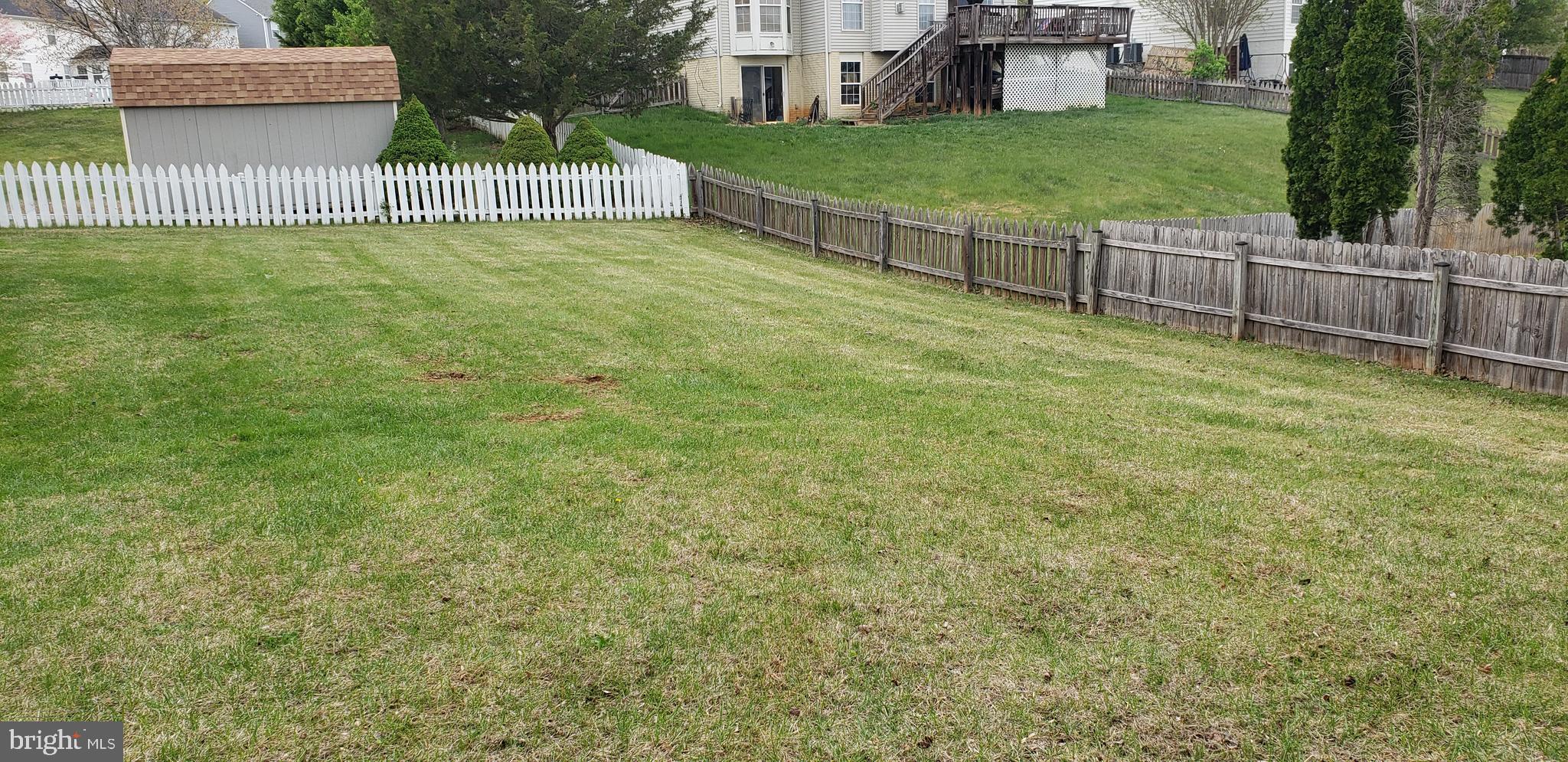 863 Fox Den Road Culpeper, VA 22701 - Photo 8 of 28 a view of a garden with a bench and trees