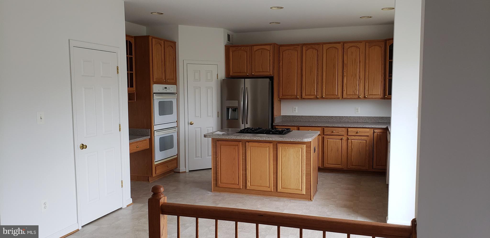 863 Fox Den Road Culpeper, VA 22701 - Photo 10 of 28 a kitchen with stainless steel appliances granite countertop a refrigerator and a stove top oven