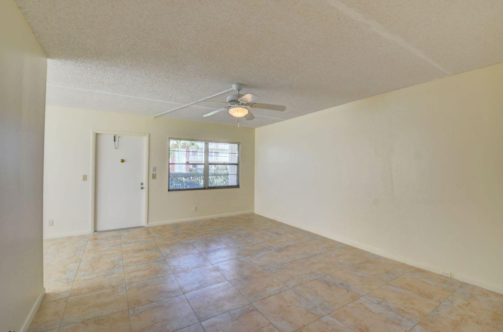 46 Brighton B Boca Raton, FL 33434 - Photo 13 of 50 an empty room with windows and entrance