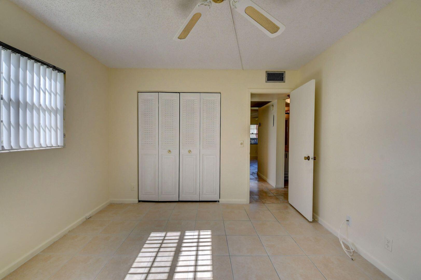 46 Brighton B Boca Raton, FL 33434 - Photo 15 of 50 a view of empty room with windows
