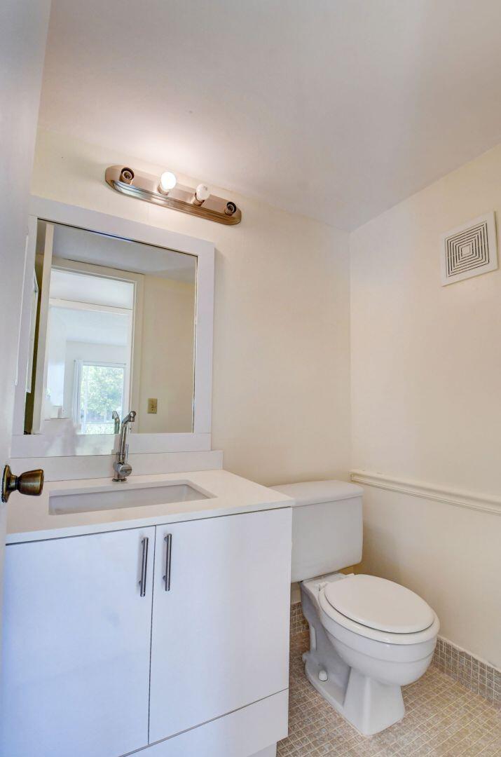 46 Brighton B Boca Raton, FL 33434 - Photo 21 of 50 a bathroom with a granite countertop toilet sink and mirror