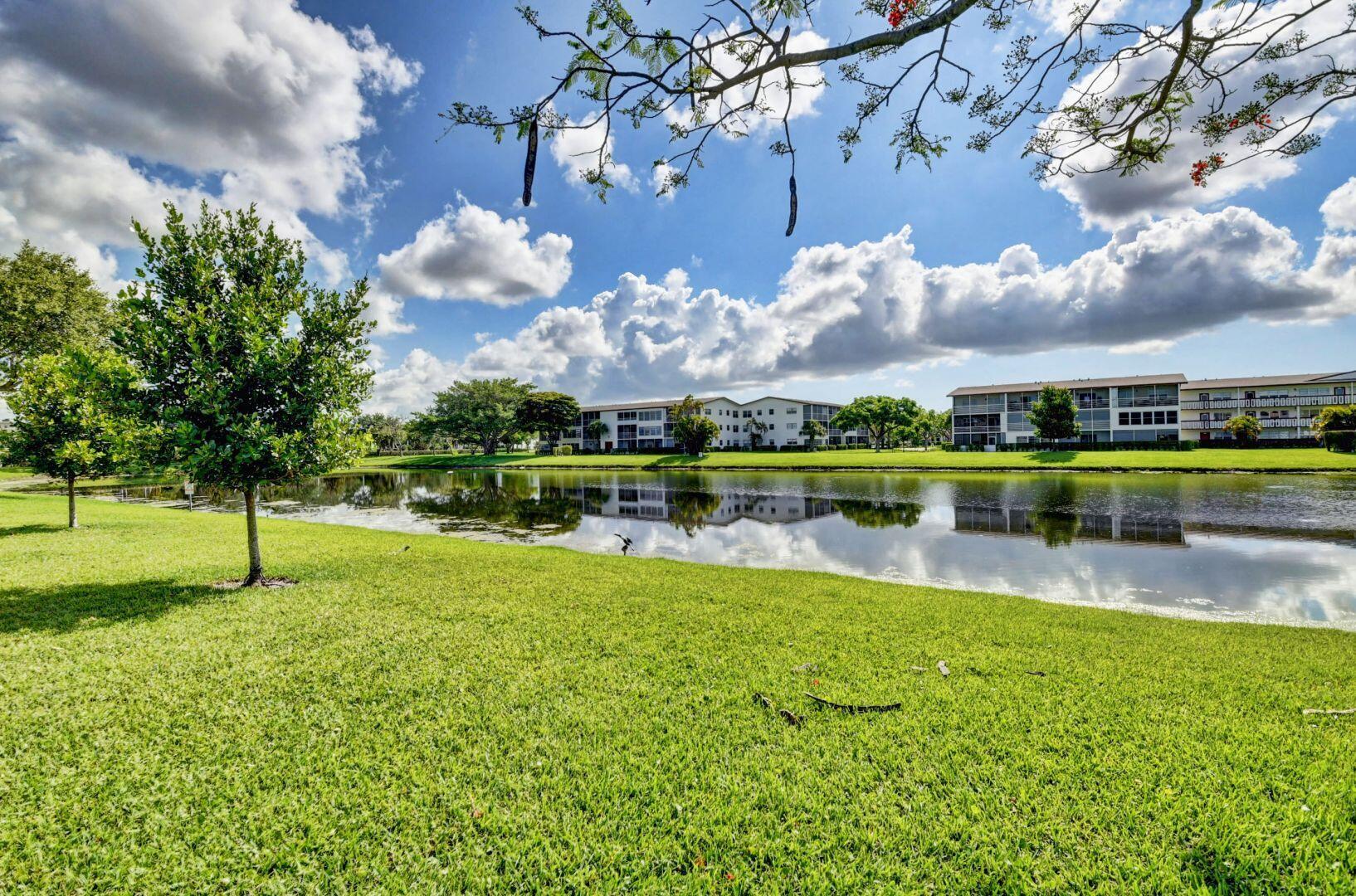 46 Brighton B Boca Raton, FL 33434 - Photo 24 of 50 a view of a lake with a house in the background