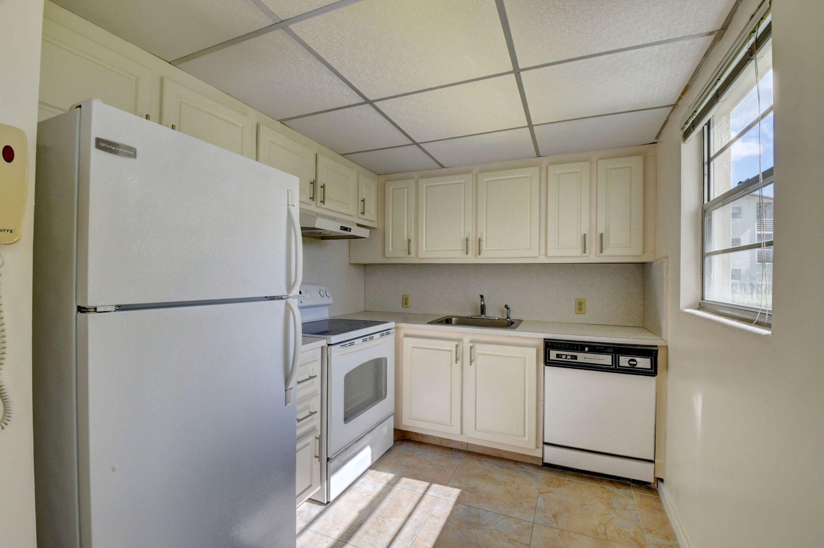 46 Brighton B Boca Raton, FL 33434 - Photo 3 of 50 a white refrigerator freezer sitting inside of a kitchen