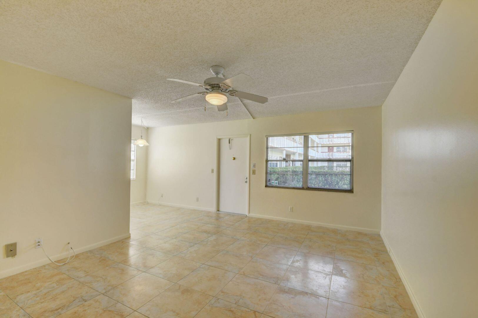 46 Brighton B Boca Raton, FL 33434 - Photo 8 of 50 an empty room with windows and fan