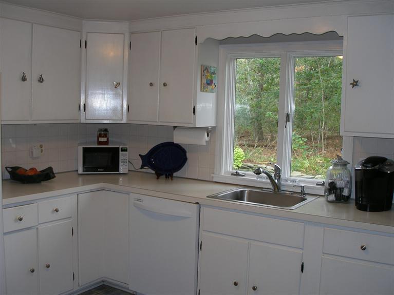 14 Paddock Pond Road Harwich, MA 02645 - Photo 14 of 28 a kitchen with stainless steel appliances white cabinets and a window