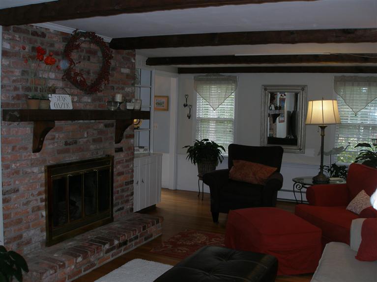 14 Paddock Pond Road Harwich, MA 02645 - Photo 19 of 28 a living room with furniture and a fireplace