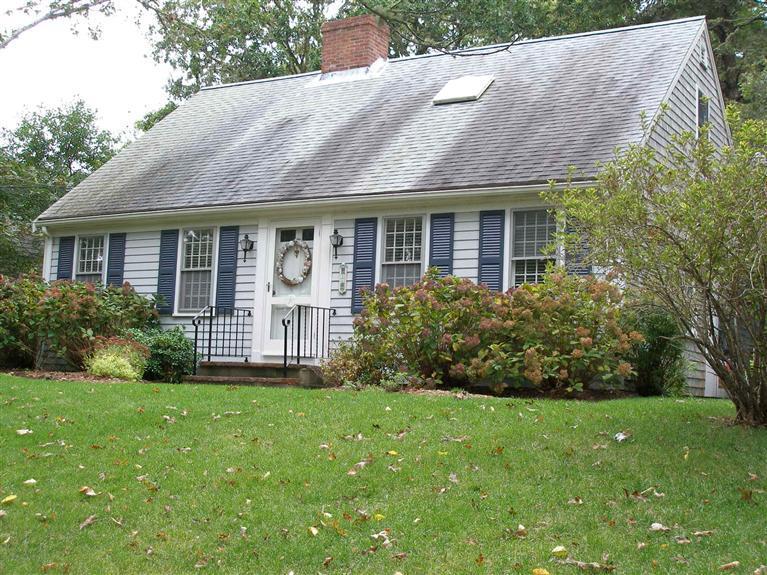 14 Paddock Pond Road Harwich, MA 02645 - Photo 3 of 28 a view of a house with brick walls and a yard with plants