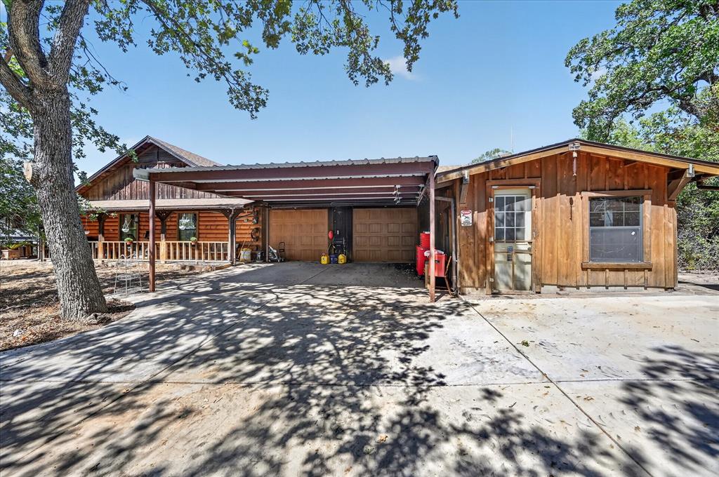 1623 3 Skillet Road Springtown, TX 76082 - Photo 30 of 40 Wood-sided main residence with a covered front porch and a covered carport