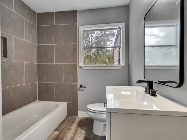 a bathroom with a sink a toilet and tub