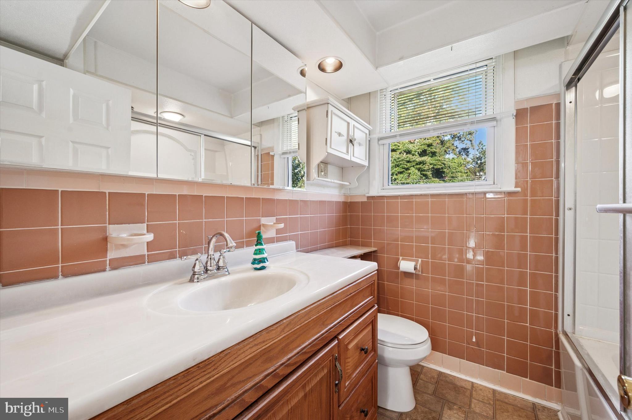 708 Cambridge Road Brookhaven, PA 19015 - Photo 11 of 20 a bathroom with a sink a toilet and shower